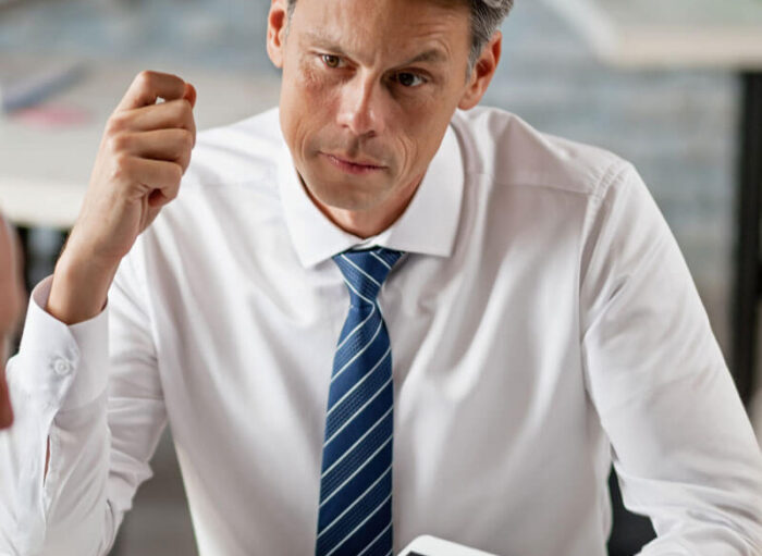 financial-advisor-senior-couple-using-digital-tablet-while-having-meeting-office